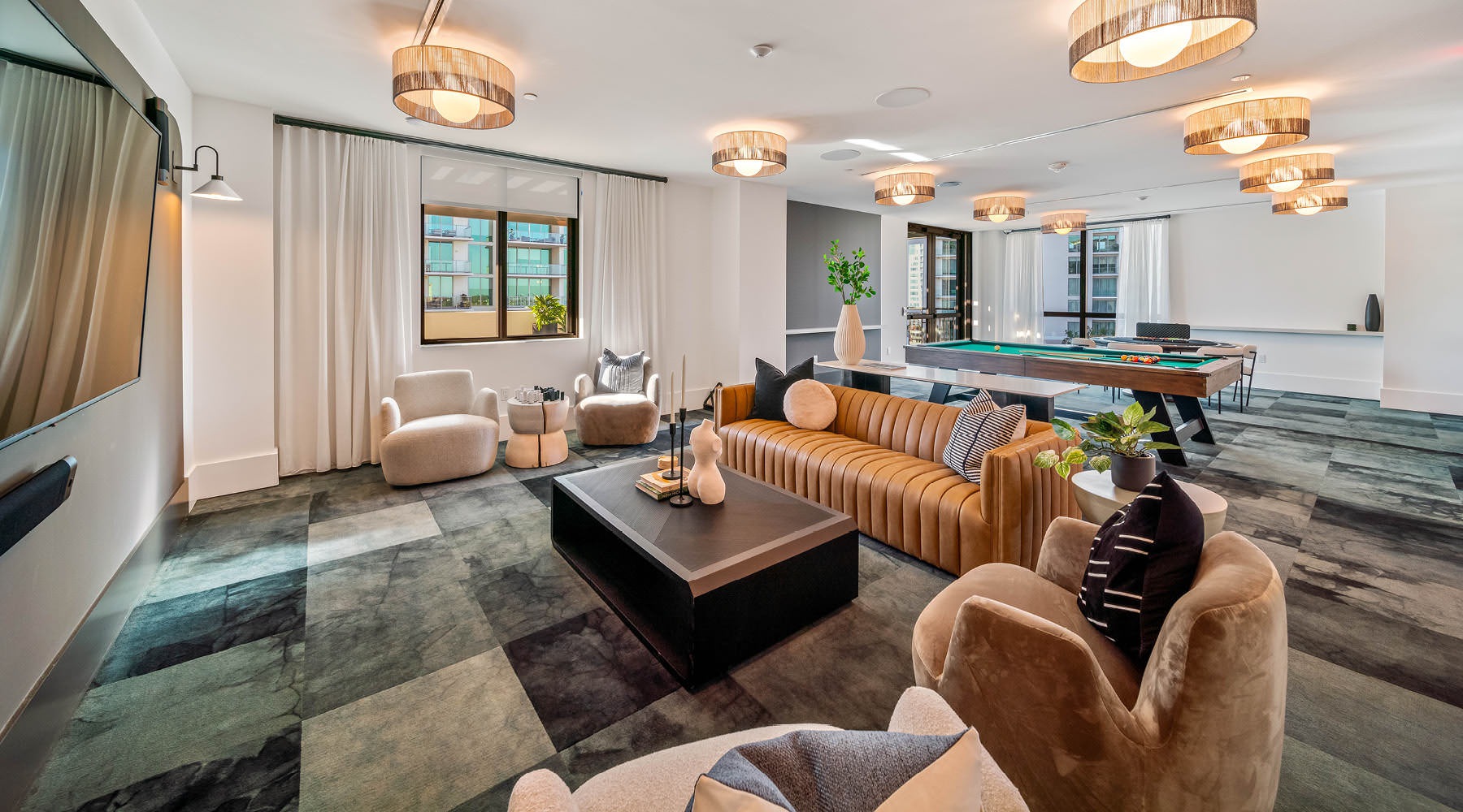 a lounge with a large tv and seating